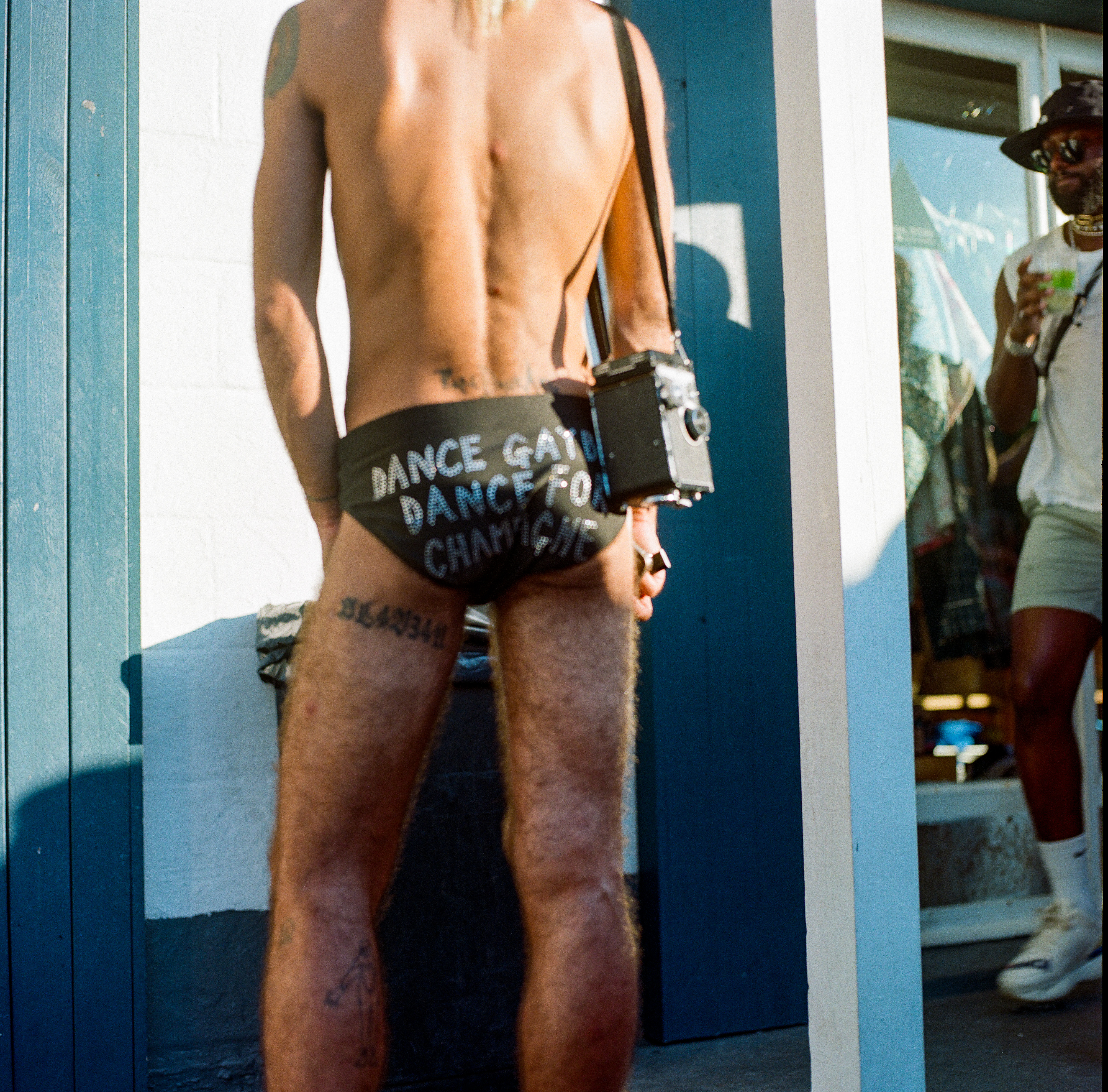 Fire Island 025, a square-format photograph street photograph made in Fire Island Pines, New York by Robert Andy Coombs.